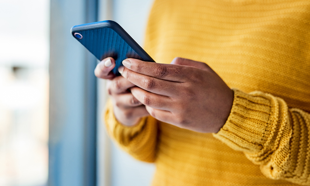 man looking at cell phone for updates